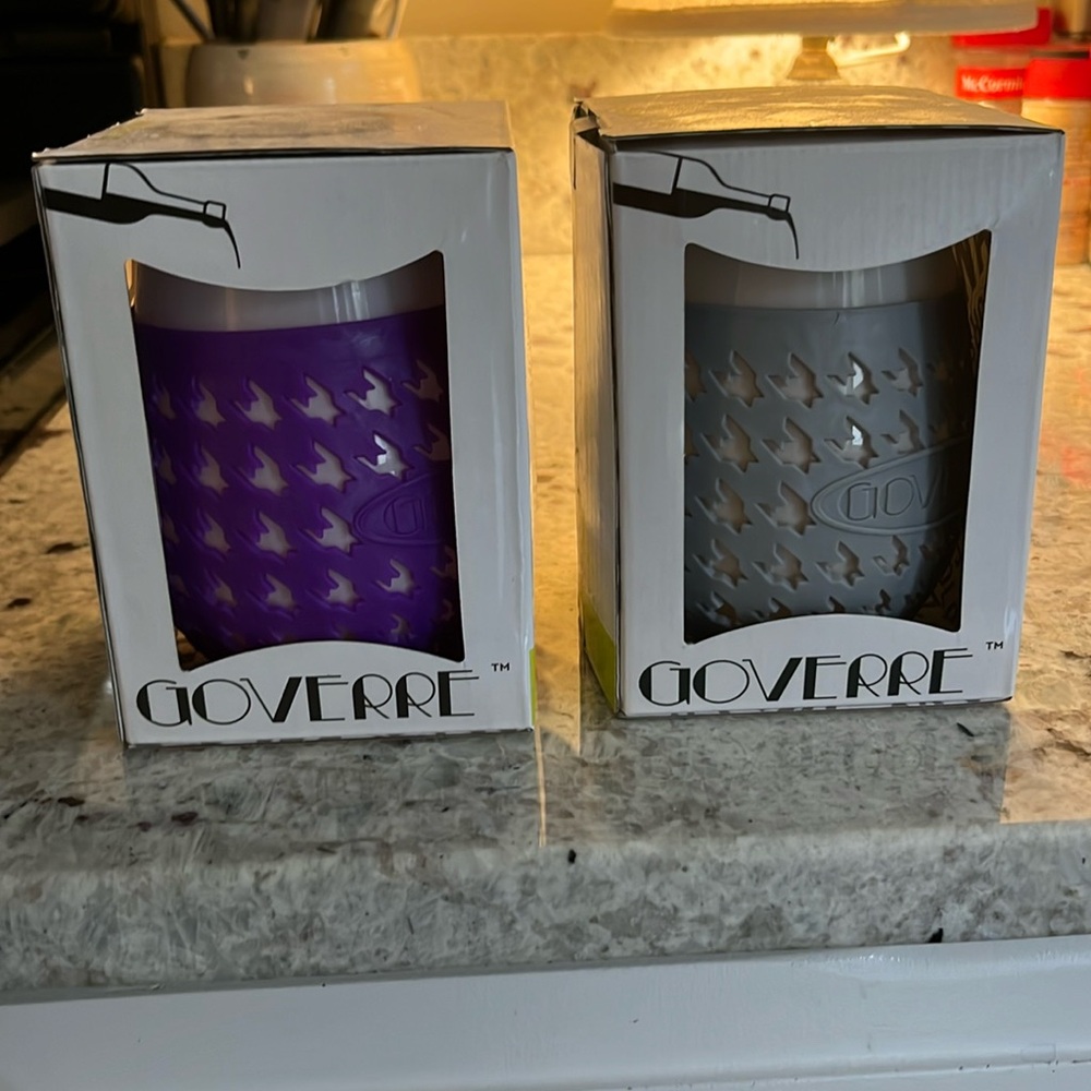 New in boxes. Two GOVERRE glasses … one purple and one gray. Silicone sleeve.